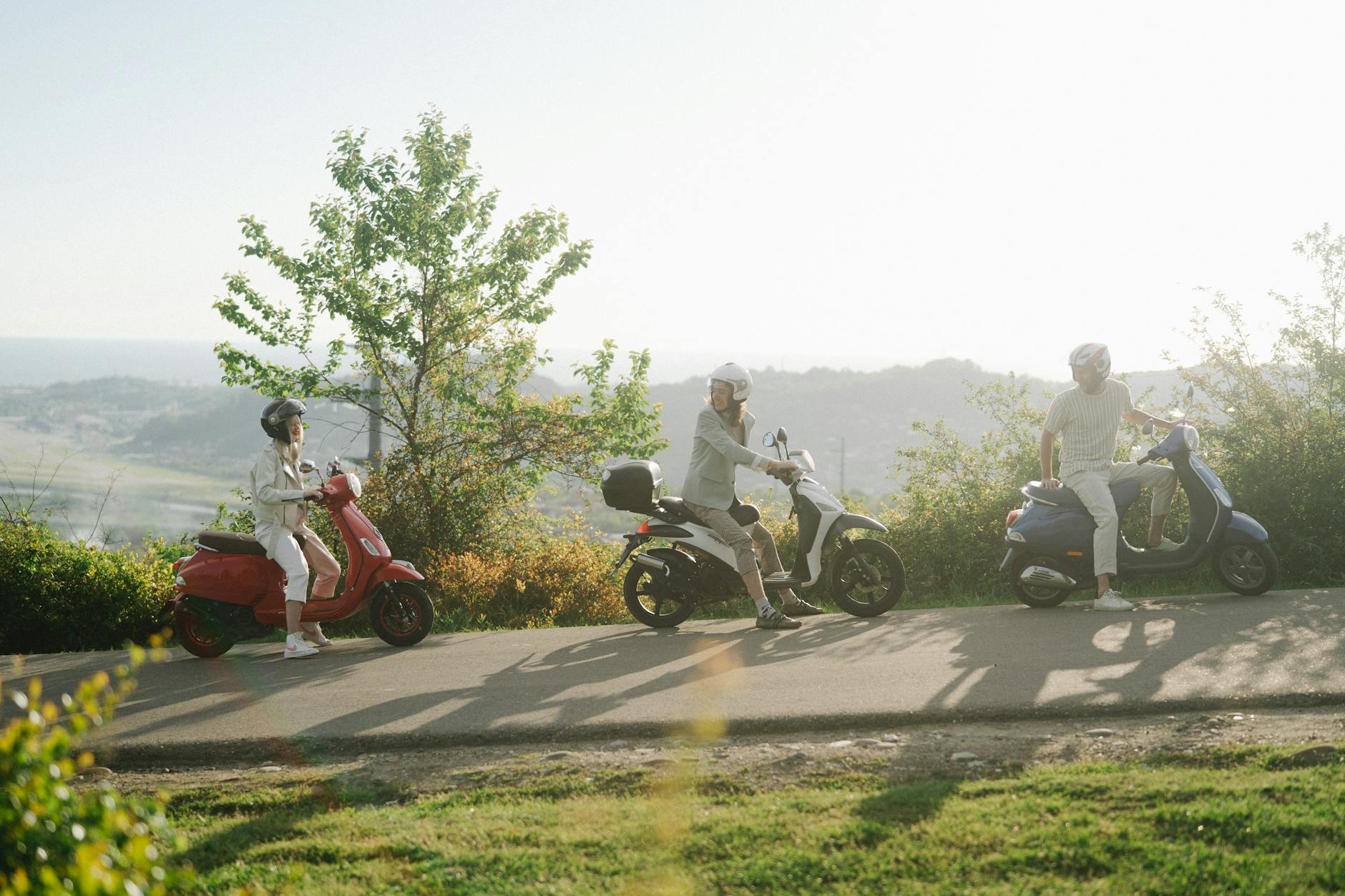 friends riding their motor scooters together
