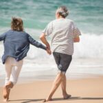 a couple running on a shore