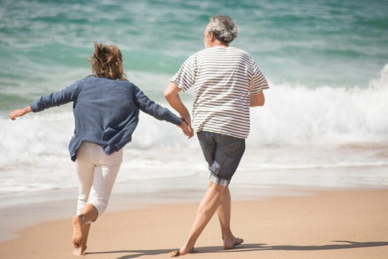 a couple running on a shore