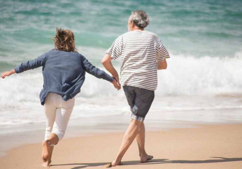 a couple running on a shore